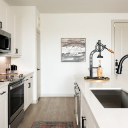 kitchen with ample counter-space, modern appliances and bright lighting