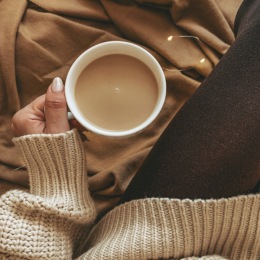 a hand holding a mug of coffee
